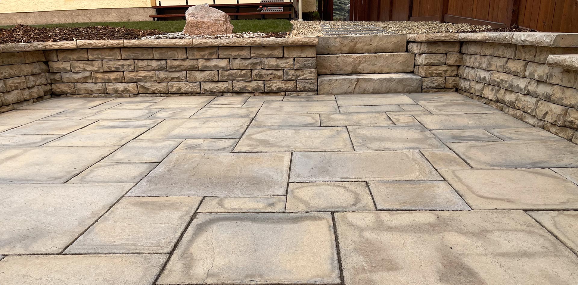 Large stone retaining wall and patio